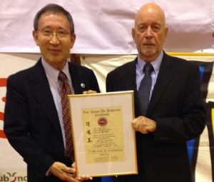 BTC Chairman Dave Oliver receiving his promotion certificate to promote him to 9th Dan Grand Master from Grandmaster C.K. Choi, 9th Dan. The award was made by: Grandmaster CK Choi, Grandmaster J. C. Kim, Grandmaster Sang Min Cho and Grandmaster Woo Yup Yang, all original tae kwon do pioneers.
